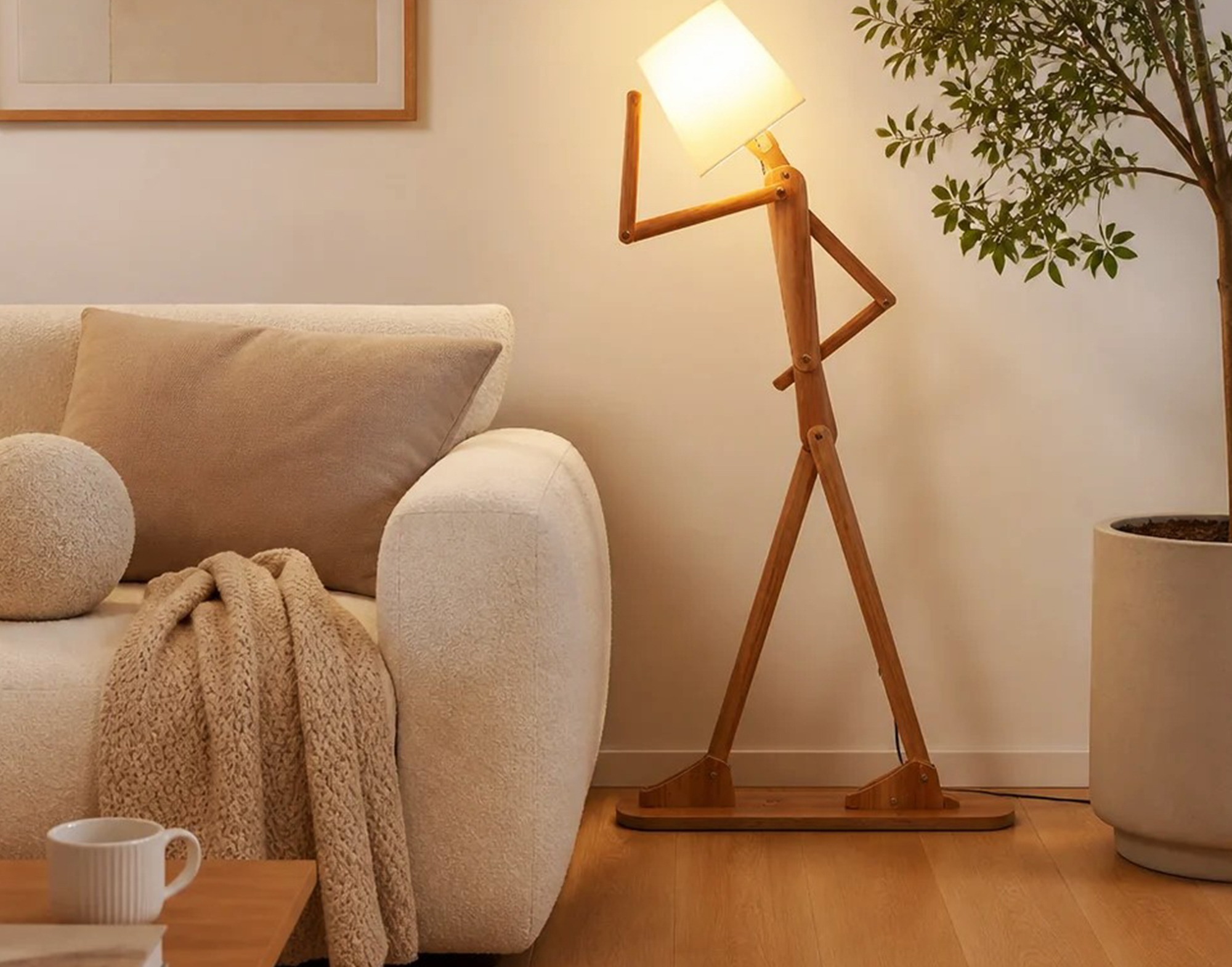 Wooden Articulated Figure Floor Lamp Beside A Cream Bouclé Sofa - Boss Interiors Gaborone